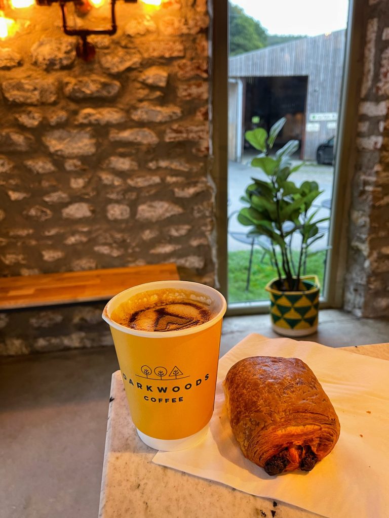 Cosy morning setup at Cat's Kitchen with coffee machine and pastry display.