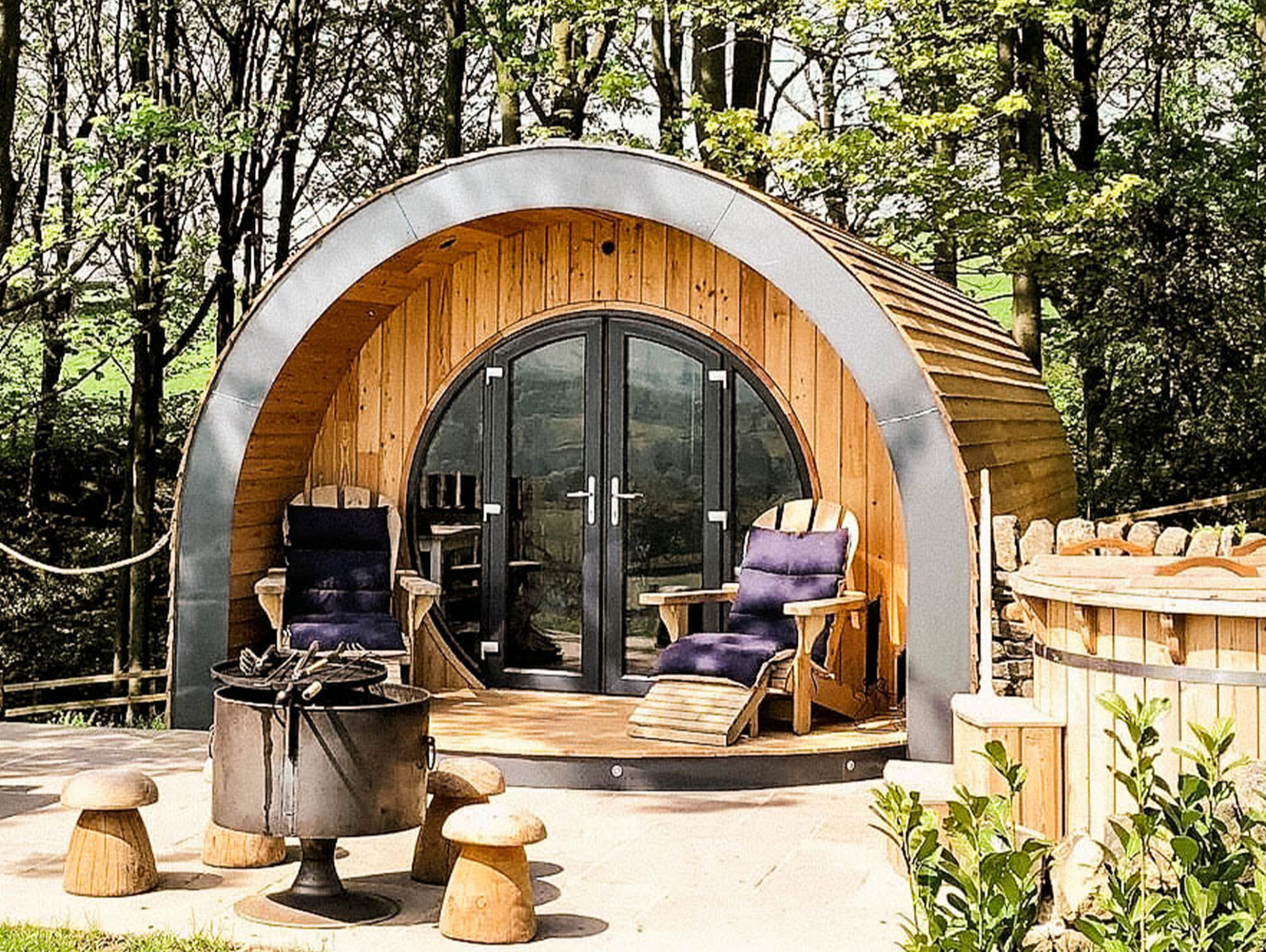 Exterior of luxury pod at Catgill Farm surrounded by nature.